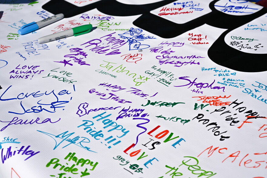 Signatures and messages of hope cover the banner to be held during TulsaPride Parade Saturday, Oct. 17.