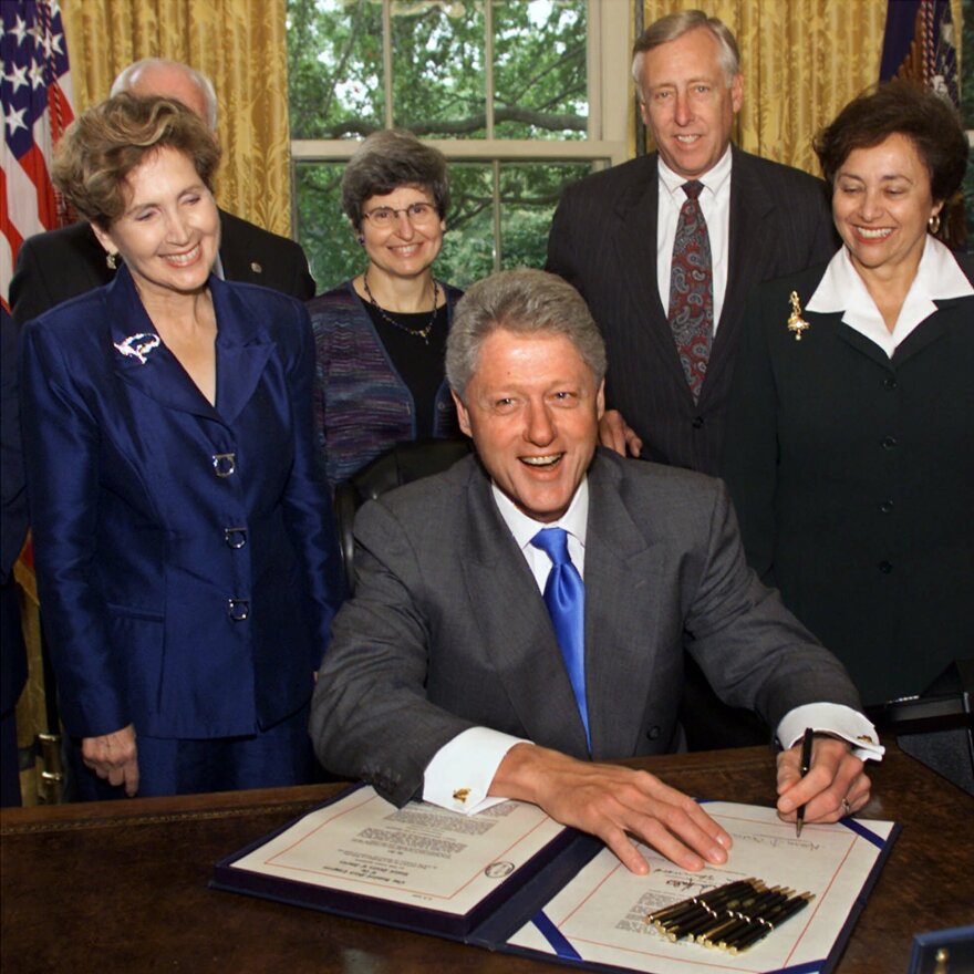 Then-Rep. Connie Morella, R-Md., looks on in the Oval Office as President Clinton signs a $28 billion bill financing the Treasury Department and providing pay increases for Congress and executive branch workers on Sept. 29, 1999.