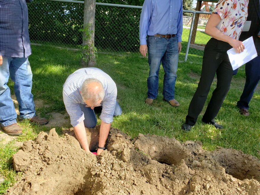 Billings City Councilman Mike Yakawich placing remains in grave