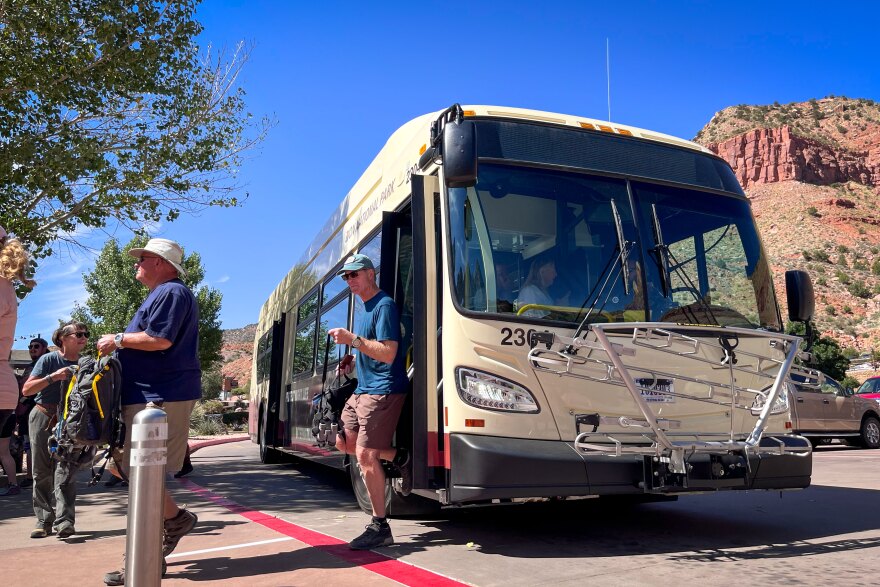 One of Zion’s new zero-emission shuttles unloads some passengers at the park’s entrance in Springdale, Sept. 22, 2023.