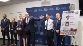 Pennsylvania Attorney General Dave Sunday (center, at podium) points to a poster highlighting the two alleged main suppliers for a cocaine-trafficking ring at Penn State's University Park campus. 