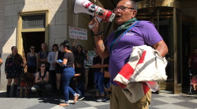 Ruben Herrera leading chants with a bullhorn at an ICE protest in July 2018.