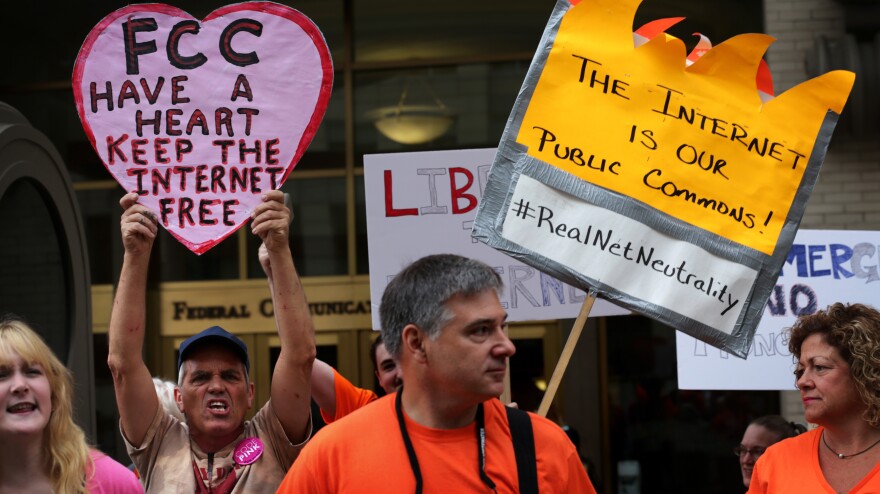 Demonstrators protest outside the Federal Communications Commission Thursday. The agency voted to open new proposed rules for public comment, including a discussion of whether "paid prioritization" should be banned.