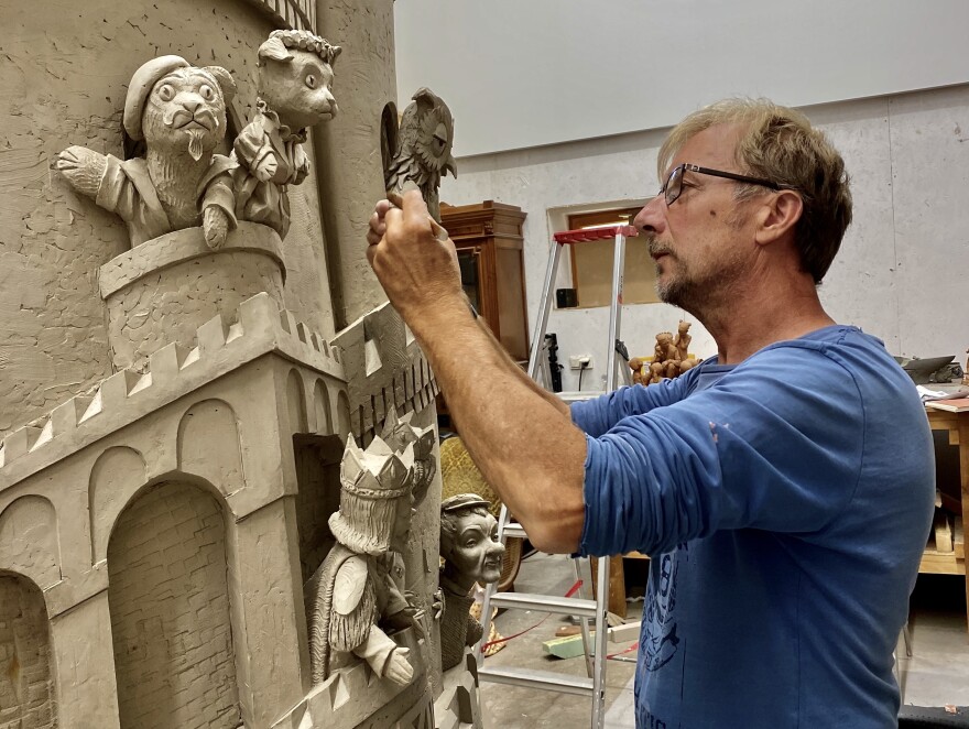 The rear portion of "A Beautiful Day for a Neighbor" features the famous castle and royal characters from <em>Mister Rogers</em>' <em>Neighborhood. </em>Sculptor Paul Day is seen here working on that portion of the piece.