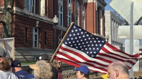 A protestor waves a flag in front of Missouri's Supreme Court on Tuesday, March 10. Protestors were opposing the state's redistricted map, which was being ruled on by the Supreme Court Justices.
