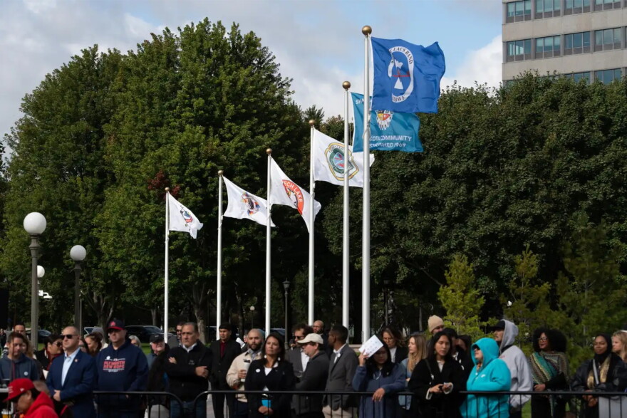 Tribal flags for six of the 11 tribal nations of Minnesota who will be permanently recognized at the state Capitol grounds wave during the Tribal Flag Plaza flag-raising ceremony in St. Paul | MPR News