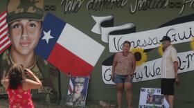 Larissa Martinez of the organization Circle of Arms takes photos at the unveiling of a San Antonio mural. It pays tribute to Vanessa Guillen and Gregory Wedel Morales, two Fort Hood soldiers who were found dead near the base in separate incidents this year.