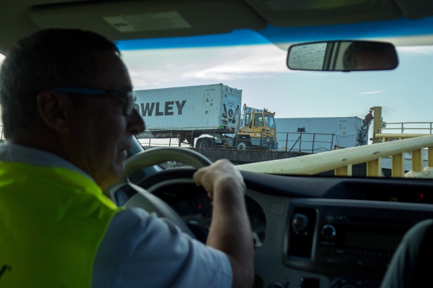 Jose Nazario, Director of Crowley's San Juan terminal operations and administration, drives as containers are unloaded from a barge in the port.