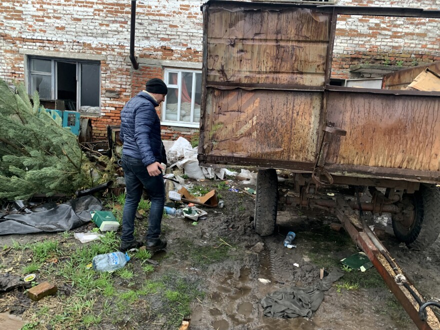 Valerii Kyselov, 36, walks past discarded meal packs near the barn where Russian soldiers slept in Bilka, Ukraine.