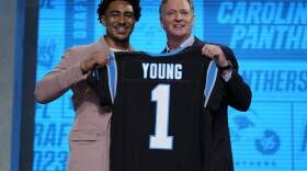 Alabama quarterback Bryce Young gets a jersey from NFL Commissioner Roger Goodell after being chosen by Carolina Panthers with the first overall pick during the first round of the NFL football draft, Thursday, April 27, 2023, in Kansas City, Mo. (AP Photo/Jeff Roberson)