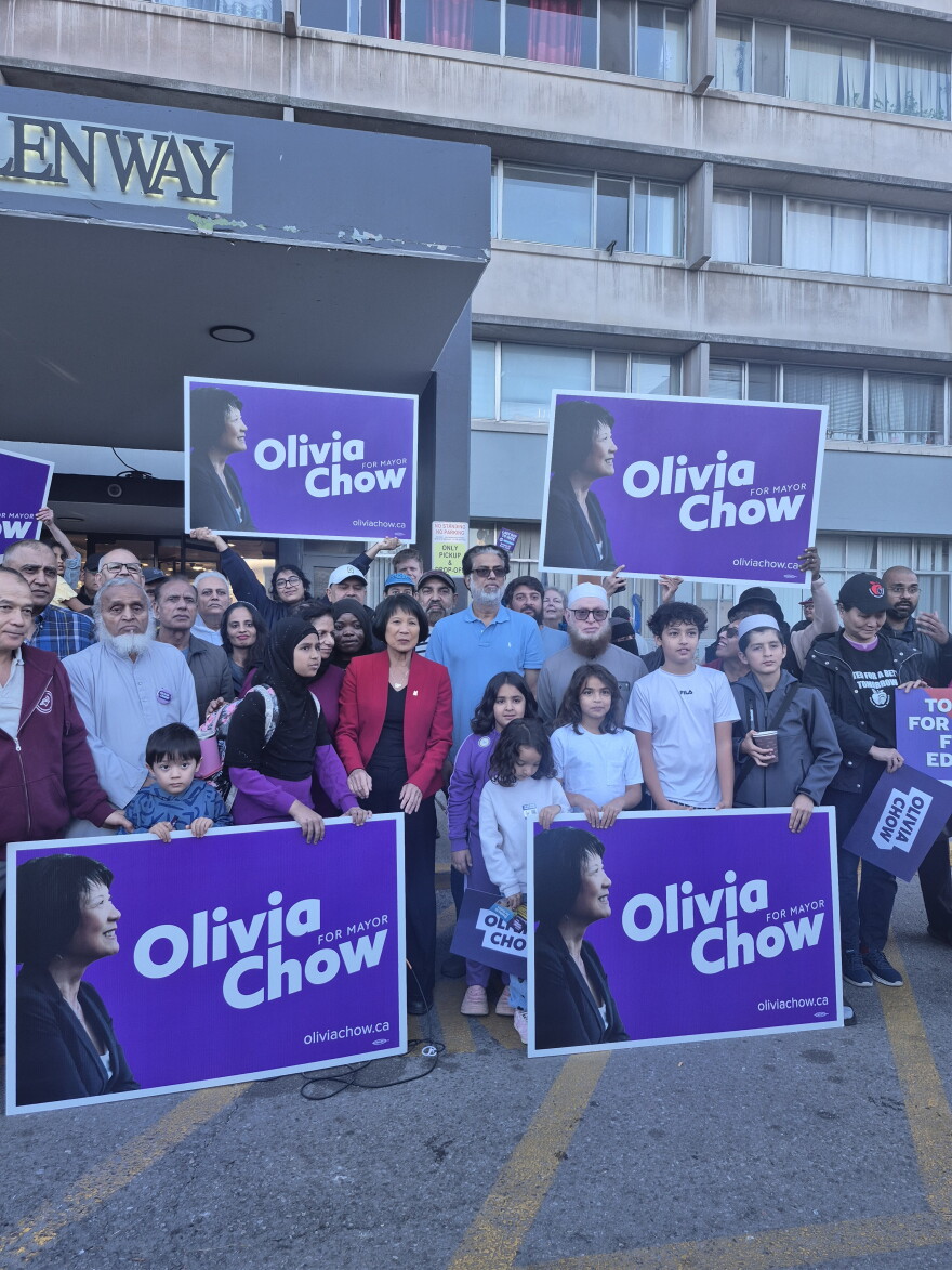 Mayor Olivia Chow poses with condo residents and campaign signs during election season