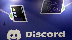 FILE - A Discord display stands at the company's booth at the Game Developers Conference 2023, in San Francisco, March 22, 2023.