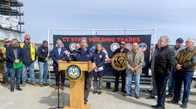 Michael O'Connor, executive director of Connecticut Port Authority at the podium during a press conference about Revolution Wind in New London on March 26, 2025. The pier will continue to assemble turbines for Sunrise Wind, another offshore wind project in New York, through the end of 2027 and will continue to be available for other wind projects should they be approved according to O’Connor.