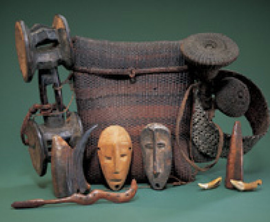 Initiation basket and contents. Plant fiber, wood, ivory, animal teeth, animal horn and buttons. Height: 13-3/8 in.