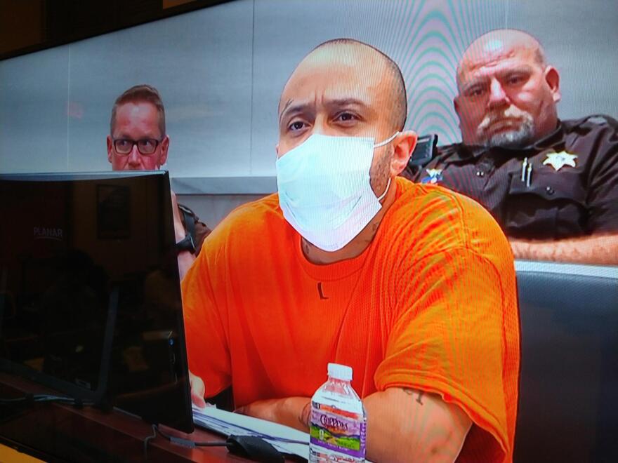 Defendant Darrell Brooks listens to witness testimony Thursday afternoon, after requesting and being granted permission to sit in the trial courtroom, instead of an adjacent courtroom used when the judge considers Brooks disruptive.