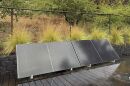 Plug-in solar panels sit on a home's outdoor deck.