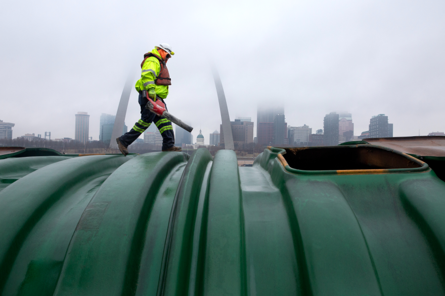 Jason Imel, a deck hand with Cargill, Inc., blows excess soybeans off the top of a river barge and closes the barge’s loading lids on Friday, Dec. 22, 2023, at Cargill, Inc.’s facility in East St. Louis, Illinois. For the third time in five years, the U.S. will import more agricultural products than it exports. However, this year’s deficit is tracking to be around $20 billion, far more than last year’s $2 billion deficit. Tristen Rouse/St. Louis Public Radio