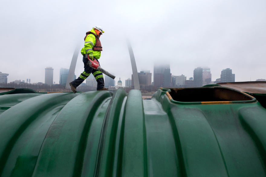 Jason Imel, a deck hand with Cargill, Inc., blows excess soybeans off the top of a river barge and closes the barge’s loading lids on Friday, Dec. 22, 2023, at Cargill, Inc.’s facility in East St. Louis. For the third time in five years, the U.S. will import more agricultural products than it exports. However, this year’s deficit is tracking to be around $20 billion, far more than last year’s $2 billion deficit.