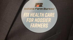 Indiana Farm Bureau members wear stickers to show support for a bill that would allow the organization to offer health benefit plan.