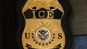 FILE - A federal agent wears an Immigration and Customs Enforcement badge in New York, June 10, 2025.
