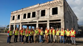 U.S. Army Corps of Engineers officials and its contractors stand in front of the last commercial property cleared on Front Street in Lahaina. Cleanup efforts were completed last week, making a major milestone in recovery.