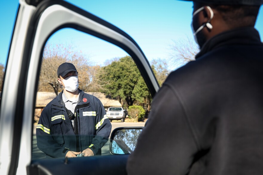 Mental health specialists with the Williamson County Mobile Outreach Team wear masks while responding to a call in December.