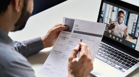 Male hr, recruiter or employer holding cv having online virtual job interview meeting with candidate on video call.