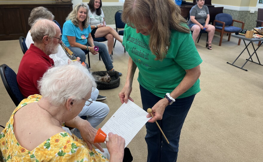 A memory cafe participant selects a song to play on the handbells.