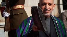 Afghan President Hamid Karzai prepares to receive U.N. Secretary-General Ban Ki-moon at the presidential palace in Kabul on Monday.