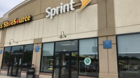 The Sprint stores at the Chouteau Crossings in North Kansas City operates next to a shuttered Payless Shoe Source. 