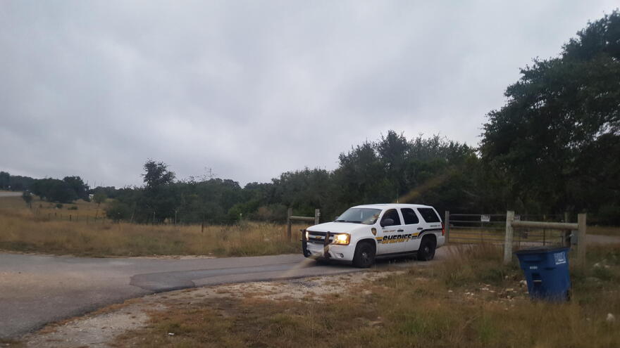 A sheriff's deputy guards the entrance to Devin Patrick Kelley's property Monday.
