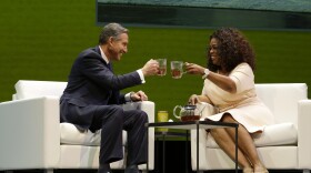Howard Schultz, left, chairman and CEO of Starbucks Coffee Company, clinks tea cups with Oprah Winfrey, right, to announce their partnership to offer Teavana Oprah Chai tea.