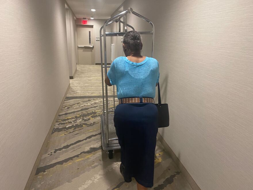 Stacks pushed a cart along the hotel corridor to pack her belongings.