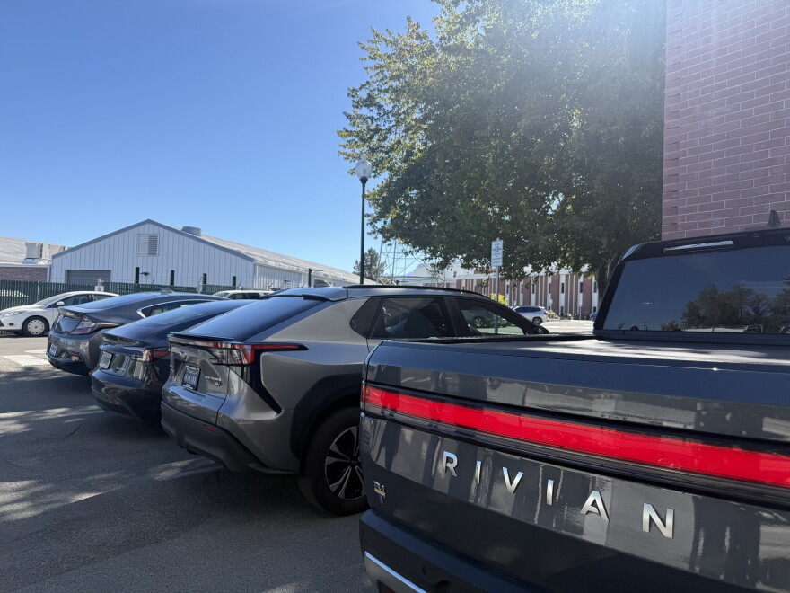 Electric Rivian R1T, Subaru Saltera, Tesla Model 3 and electric plug-in hybrid Chevy Bolt parked outside the KUNR studio in Reno, Nevada, on Sept. 29, 2026.