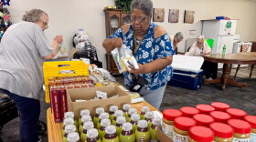 Linda Rufus selects food from the Food Bank of Iowa at an apartment complex in Storm Lake, Iowa, on Thursday, July 16, 2026. Rufus said the pop-up pantry at Storm Lake Senior Living helps her make ends meet.