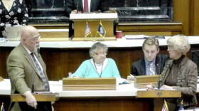 Reps. Tim Brown (R-Crawfordsville) and Sue Errington (D-Muncie) discuss the to-be-appointed Muncie school board on the House floor Wednesday evening