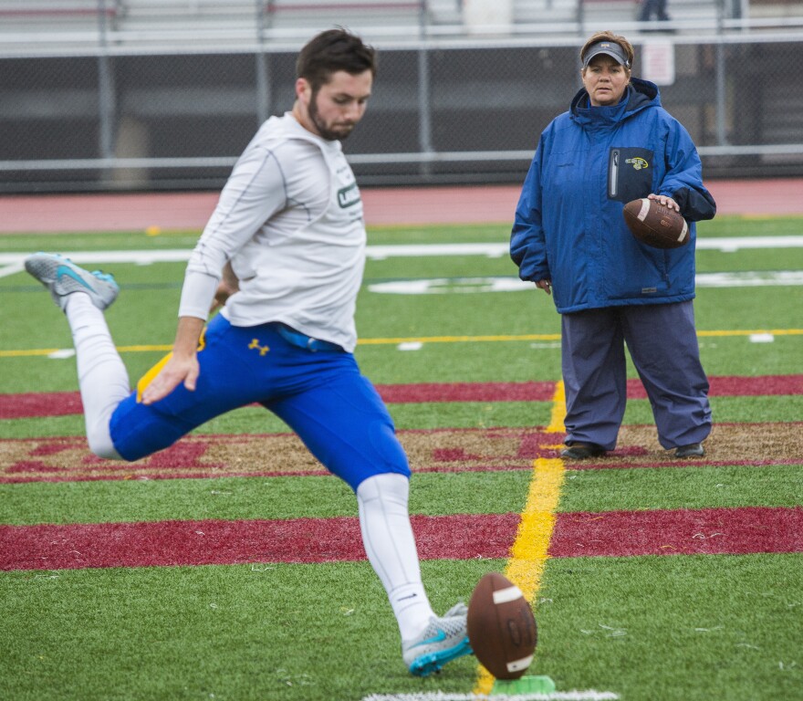 Sister Lisa runs through drills with the Saints' kicker Donovan Blatz prior to their game against Westminster at Public Schools Stadium in Duluth, Minn. The College of St. Scholastica would go on to defeat Westminster 48-12 and clinch the Upper Midwest Athletic Conference championship.
