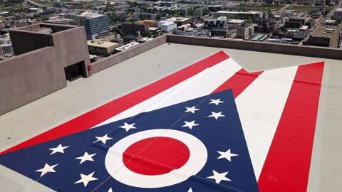 Crews added a giant Ohio flag to the roof of the Rhodes State Office Tower in Columbus during maintenance of the concrete roof.