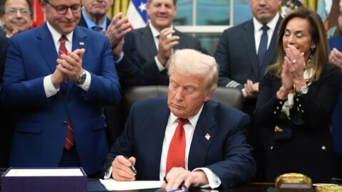 President Donald Trump signs the funding bill to reopen the government, in the Oval Office of the White House, Wednesday, Nov. 12, 2025, in Washington.