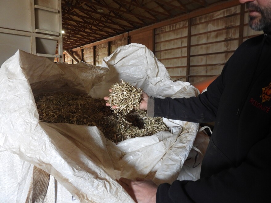 Matt Willse with a bulk bag of hemp that has been milled in his facility.