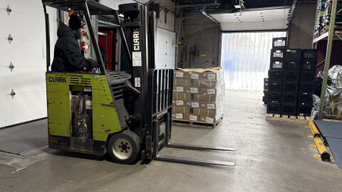 40,000 pounds of spare ribs being unloaded at the Great Plains Food Bank.