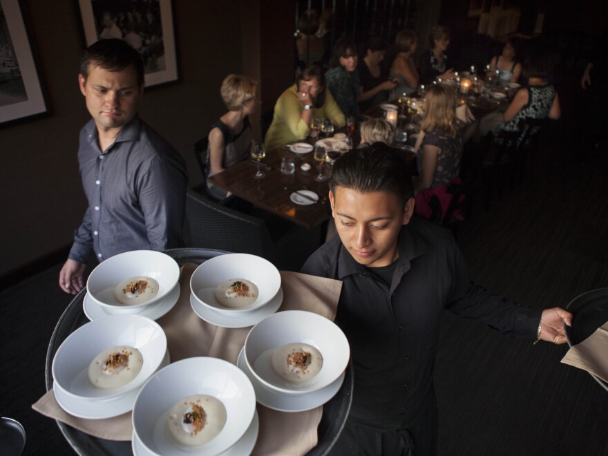 Waiters at Ardeo-Bardeo in Washington, D.C. serve smoked white potato mousse with egg and caviar.