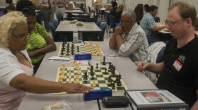 Clairborne Elementary gifted resource teacher Chris Wilson (front right) plays special education resource teacher Annie Fox in the chess tournament as Audubon Elementary computer lab teacher Contessa Hunt (back left) and Melsrose Elementary fourth grade t