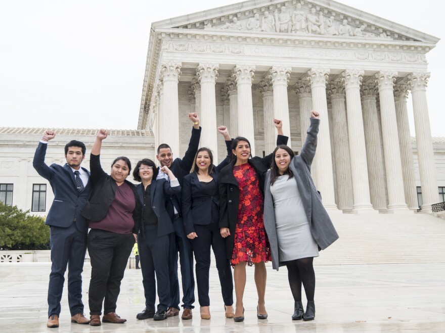 DACA recipients, including Carolina Fung Geng, (3rd from left), plaintiff Martin Batalla Vidal (center) and Eliana Fernández (3rd from right) hold their fists in the air as they enter the U.S. Supreme Court on Tuesday, Nov. 12, 2019.