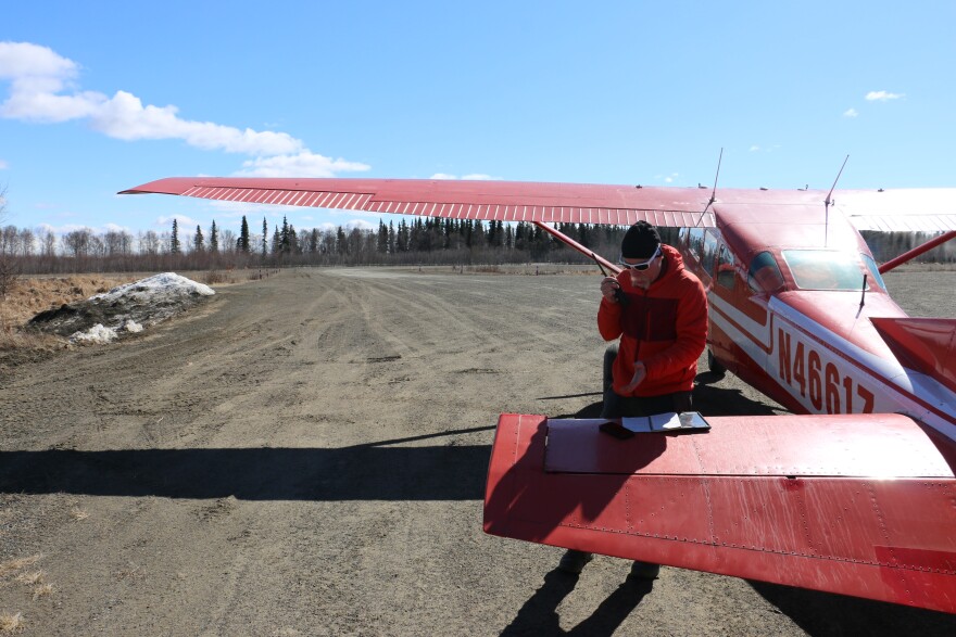 National Weather Service hydrologist Johnes Ostman radios out changes in river breakup to community members along the Kuskokwim from the Lower Kalskag airstrip on May 8, 2026.