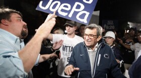 Scott Paterno, left, greeted his father — Penn State football coach Joe Paterno — as the coach arrived at his home, Tuesday evening in State College, Pa. Hundreds of students had gathered to show support for the coach.