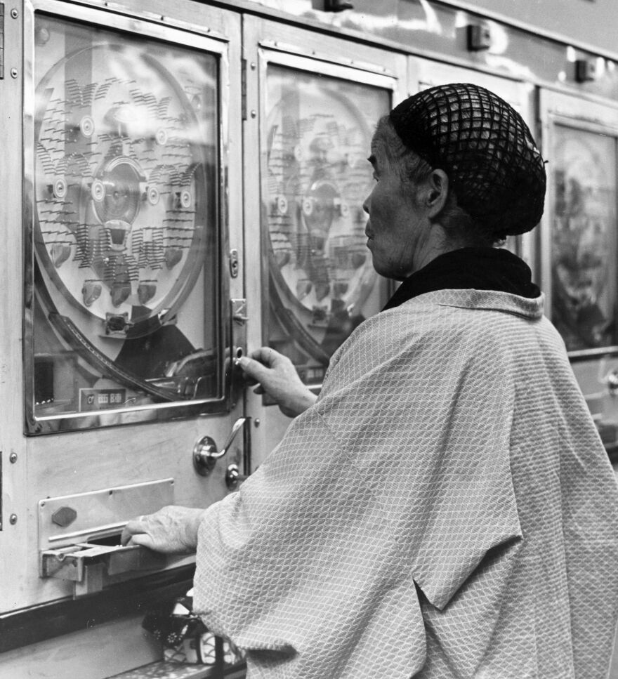 A woman gambles in a Japanese pachinko parlor circa 1955.