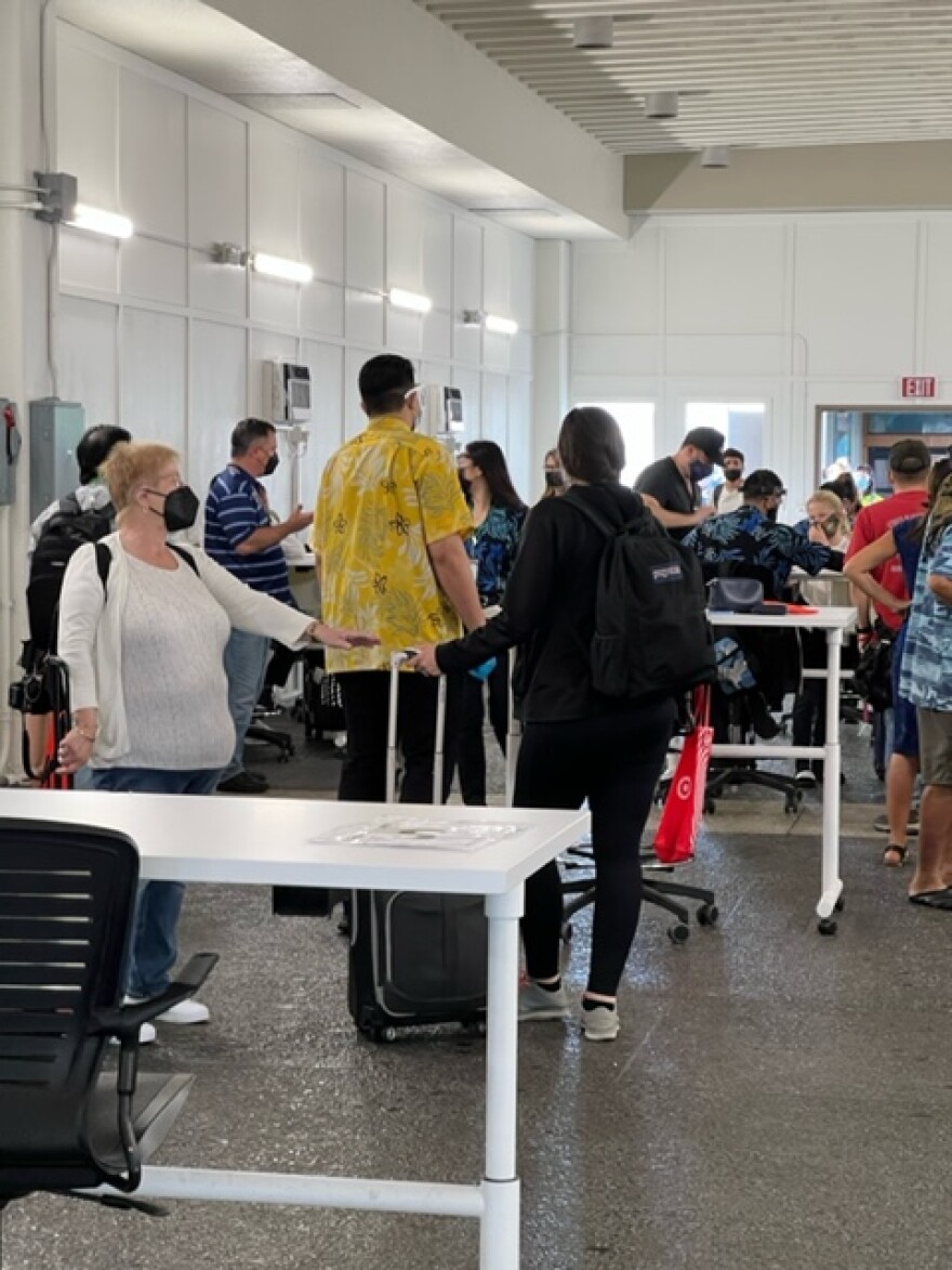 Arriving passengers at Honolulu airport stand in line for the Safe Travels program on Friday, March 25, 2022.