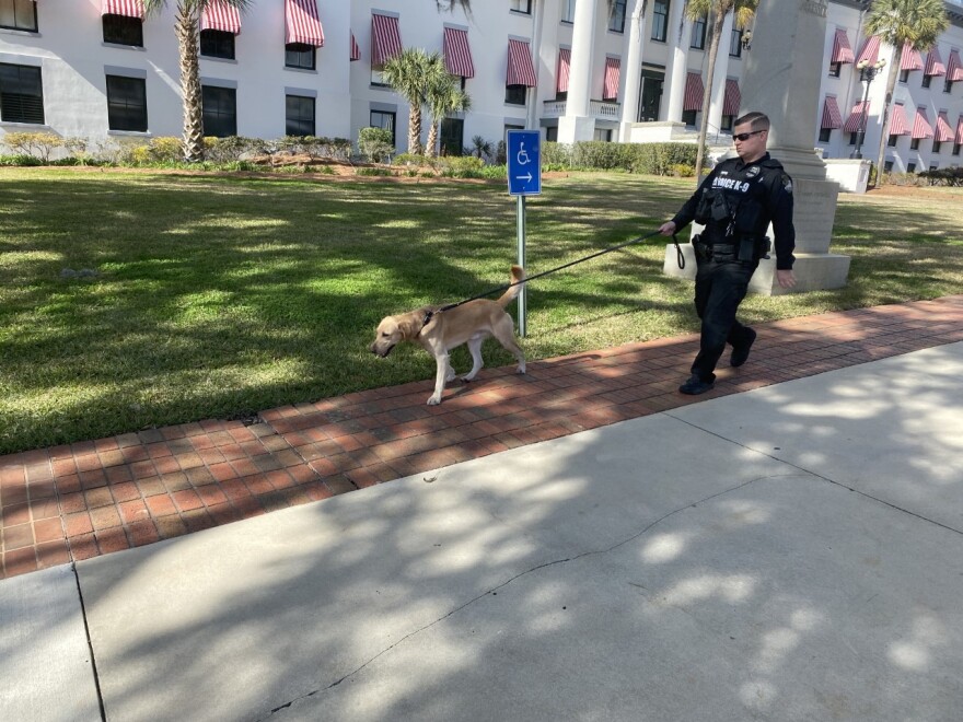 A Florida Department of Law Enforcement officer walks the capitol complex with a bomb-sniffing dog