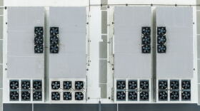 An aerial image directly above the roof of a data center. The structure contains rows of fans. 